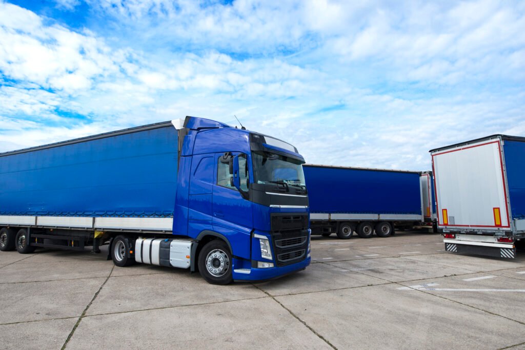 Truck vehicle with trailers in background.
