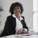 side-view-smiley-woman-working-desk